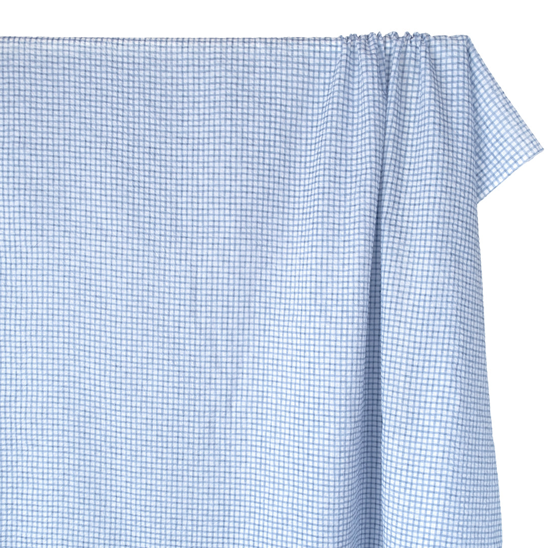 Natural fiber crinkled seersucker cotton in baby blue and white check grid print